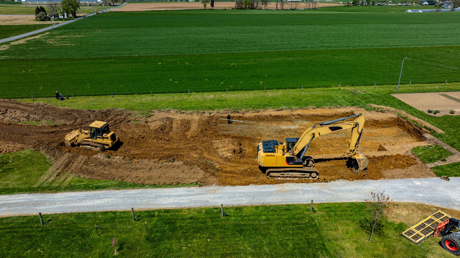 Construction Site With Heavy Machinery Working on Earth Excavation in Rural Landscape